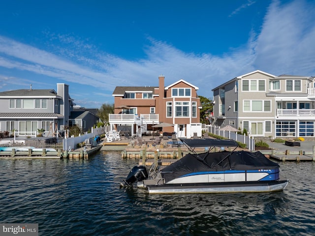 dock area featuring a water view and a balcony