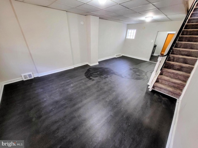 basement with a paneled ceiling