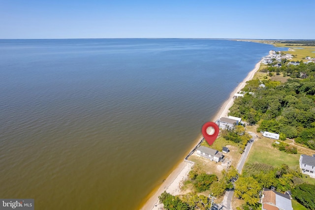 aerial view with a water view and a beach view