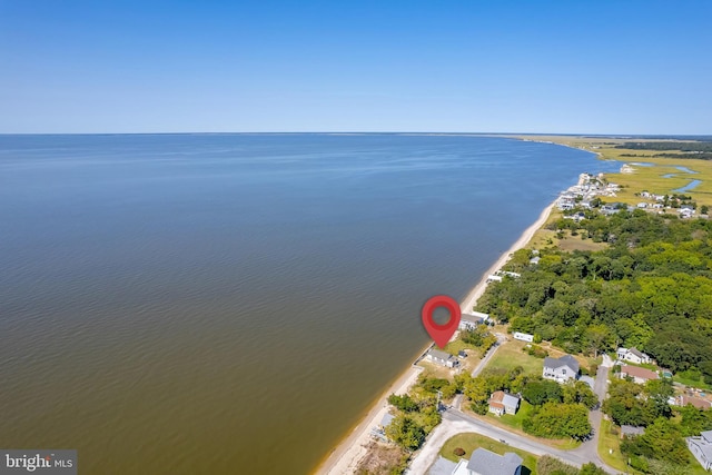 birds eye view of property with a water view and a beach view