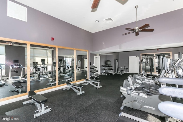 workout area with a towering ceiling and ceiling fan