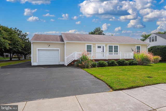 ranch-style house featuring a front yard and a garage