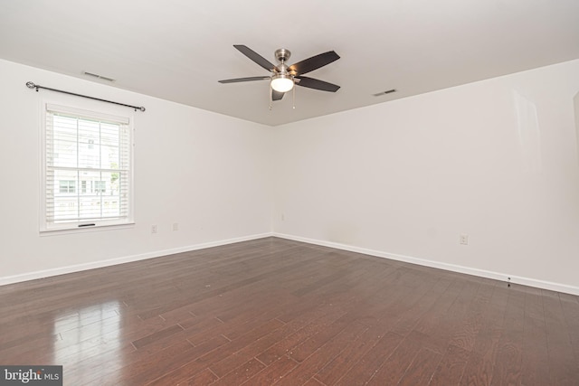 unfurnished room featuring ceiling fan and dark hardwood / wood-style floors