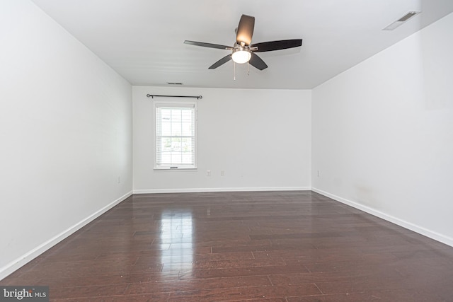 unfurnished room featuring ceiling fan and dark wood-type flooring