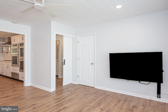 living room with ceiling fan and hardwood / wood-style floors