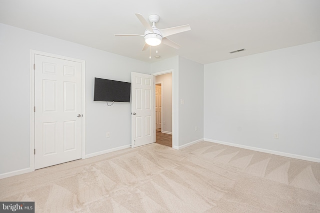 unfurnished bedroom with ceiling fan and carpet floors