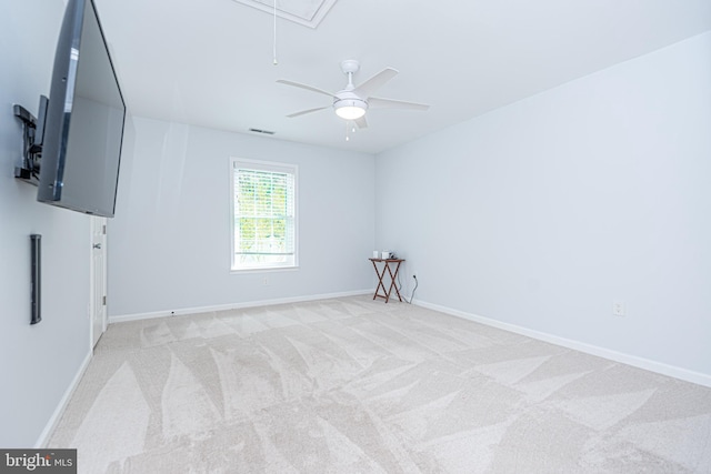 carpeted spare room featuring ceiling fan