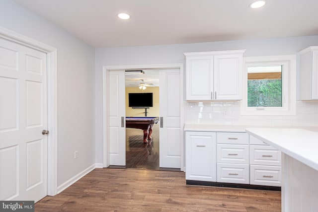 kitchen with pool table, backsplash, dark wood-type flooring, and white cabinets