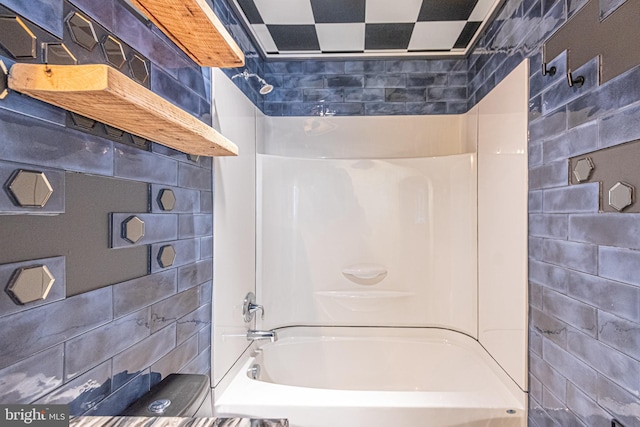 bathroom featuring tub / shower combination and tile walls