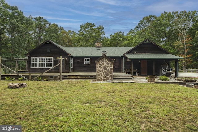 rear view of house featuring a lawn and a patio