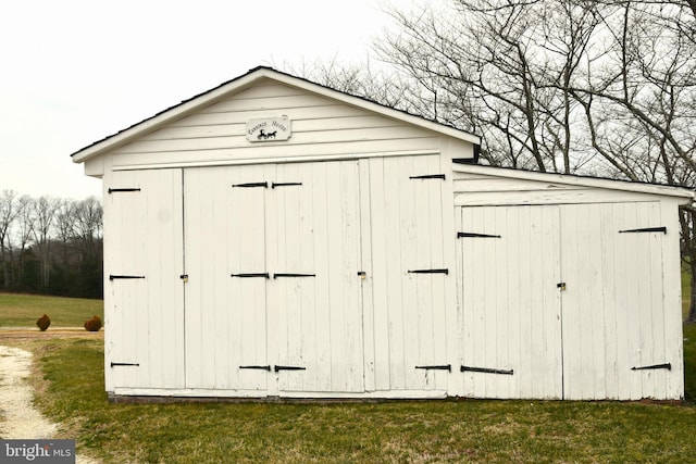 view of outdoor structure with a lawn