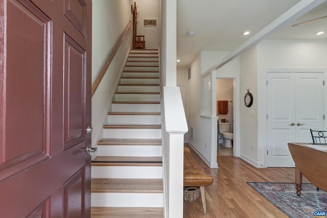 stairs featuring hardwood / wood-style flooring