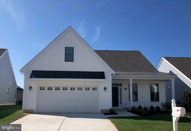 modern inspired farmhouse featuring a front yard and a garage