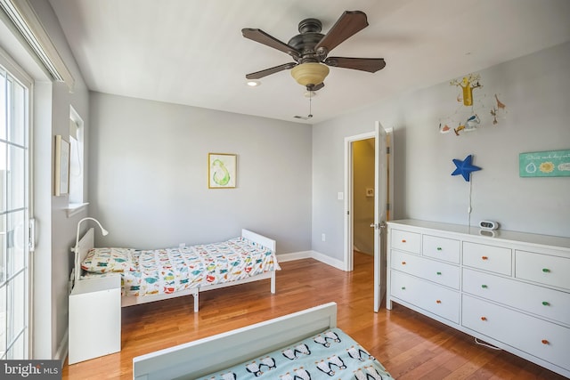 bedroom with hardwood / wood-style flooring and ceiling fan