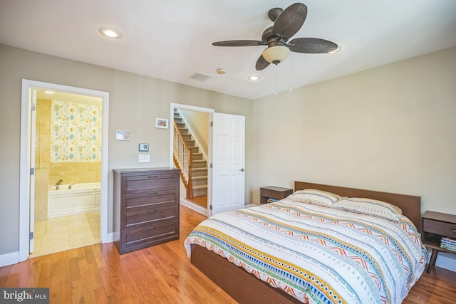 bedroom featuring ensuite bathroom, ceiling fan, and light hardwood / wood-style flooring