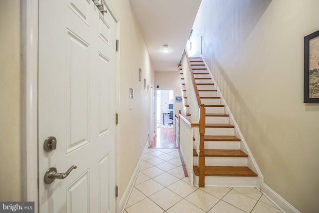 staircase featuring tile patterned flooring