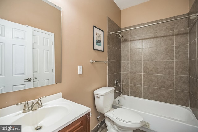 full bathroom featuring tiled shower / bath combo, vanity, and toilet