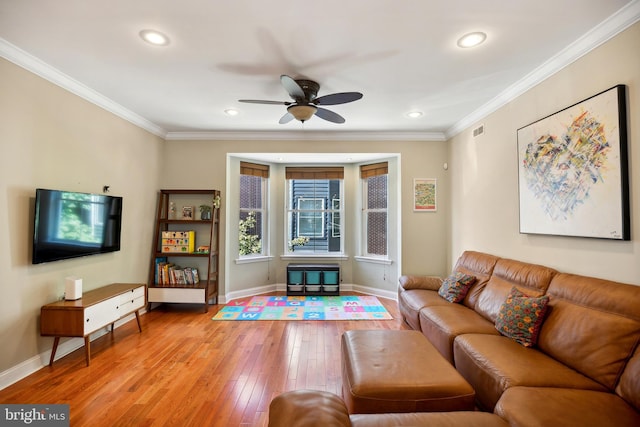 living room with ceiling fan, crown molding, and hardwood / wood-style floors