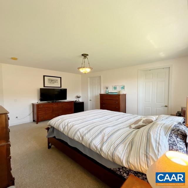 bedroom with light colored carpet