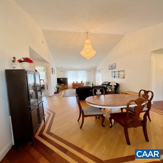 dining area with vaulted ceiling and hardwood / wood-style floors