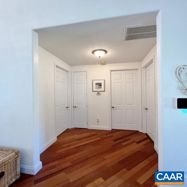 corridor featuring dark wood-type flooring