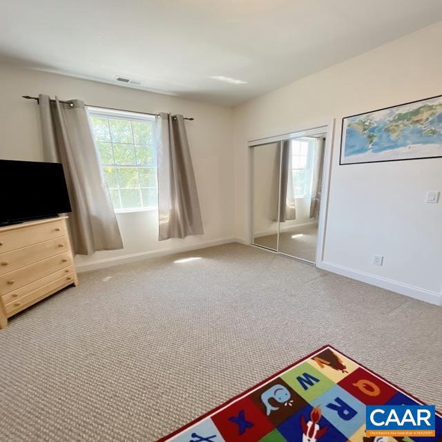 carpeted bedroom featuring a closet