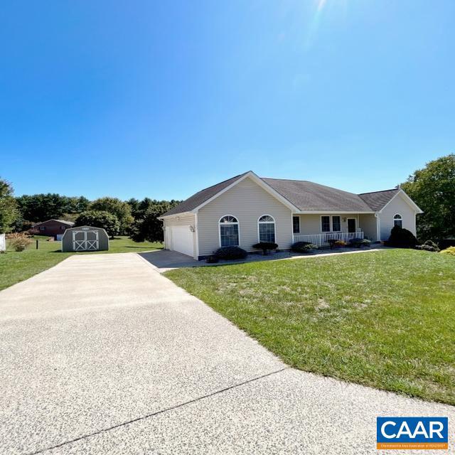 view of front of house with a garage and a front lawn