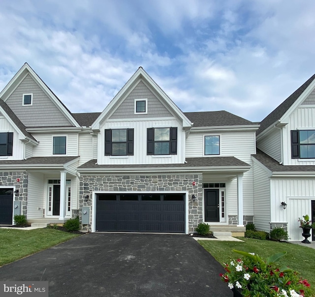 multi unit property with a garage and a front lawn