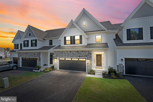 view of front facade with a yard and a garage