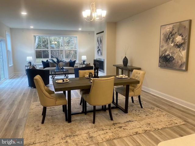 dining room featuring an inviting chandelier and light wood-type flooring