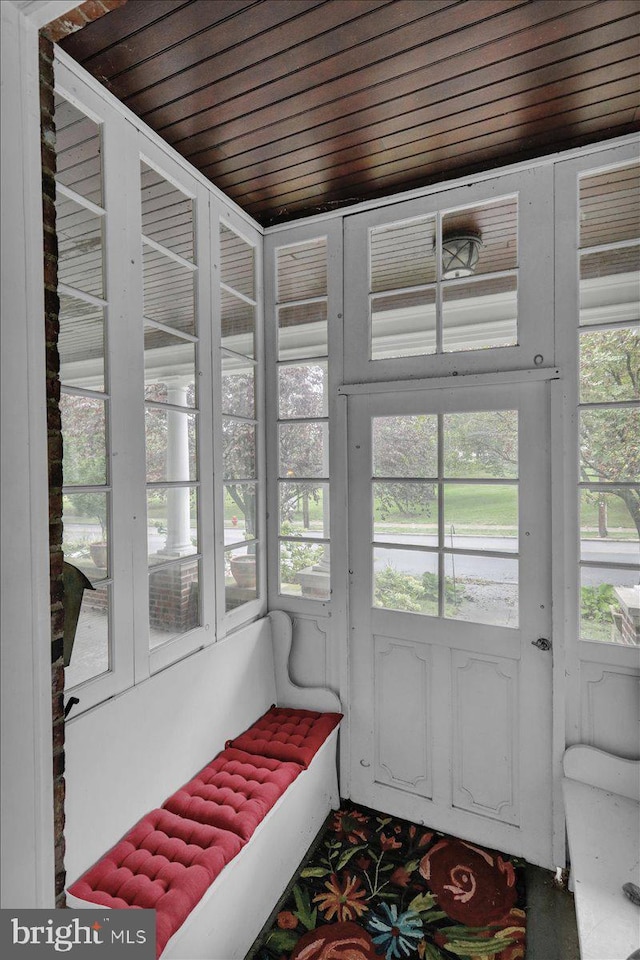 sunroom / solarium featuring wood ceiling