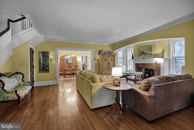 staircase featuring wood-type flooring, vaulted ceiling, and crown molding