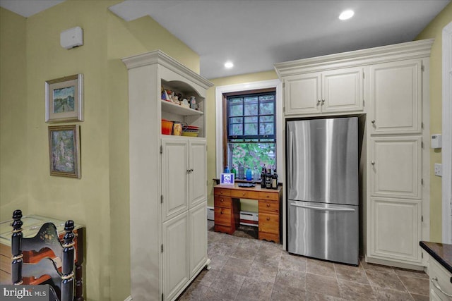 kitchen with white cabinets and stainless steel refrigerator