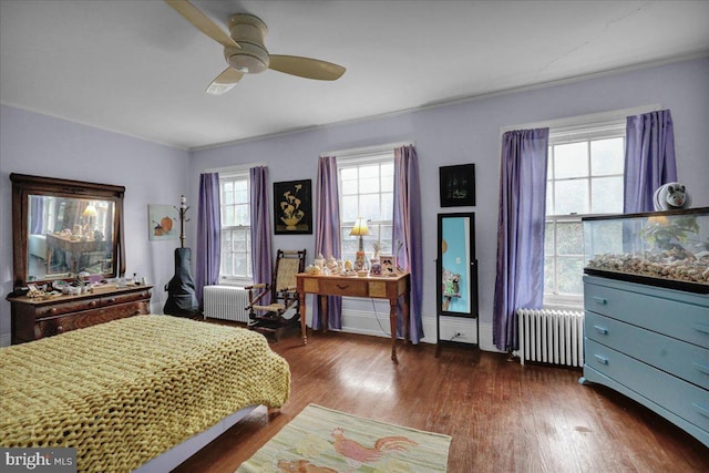 bedroom featuring radiator heating unit, ceiling fan, and dark wood-type flooring