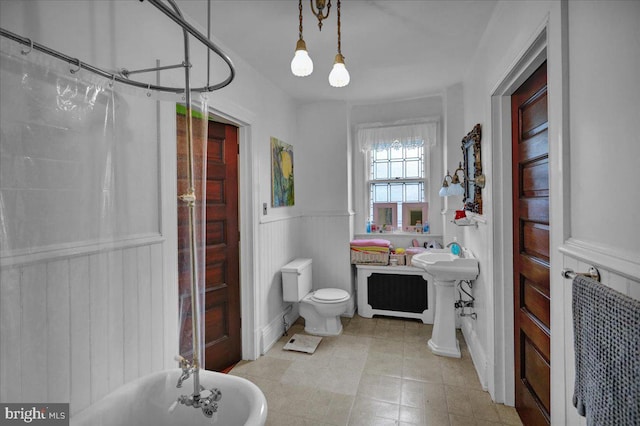 bathroom featuring plus walk in shower, toilet, and tile patterned floors