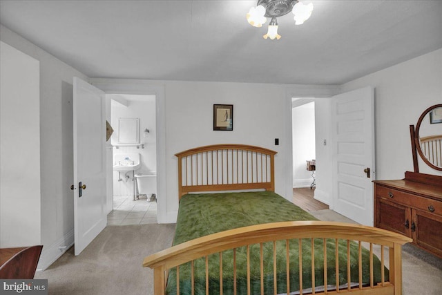 carpeted bedroom featuring ensuite bathroom