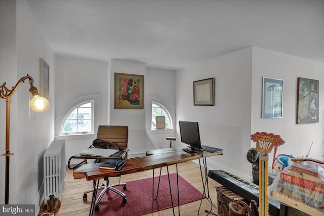 office area with light hardwood / wood-style flooring and radiator