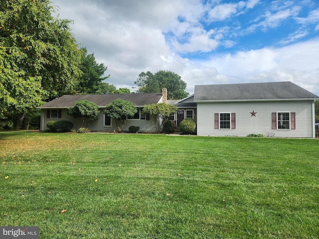 rear view of house with a lawn