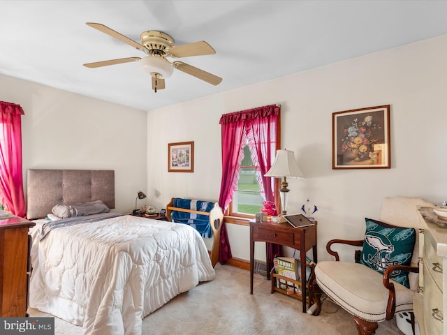 bedroom with light carpet and ceiling fan