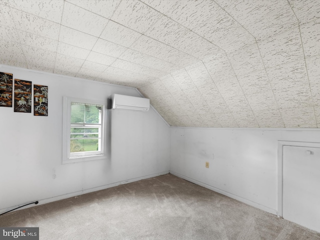 additional living space featuring vaulted ceiling, a wall unit AC, and carpet flooring