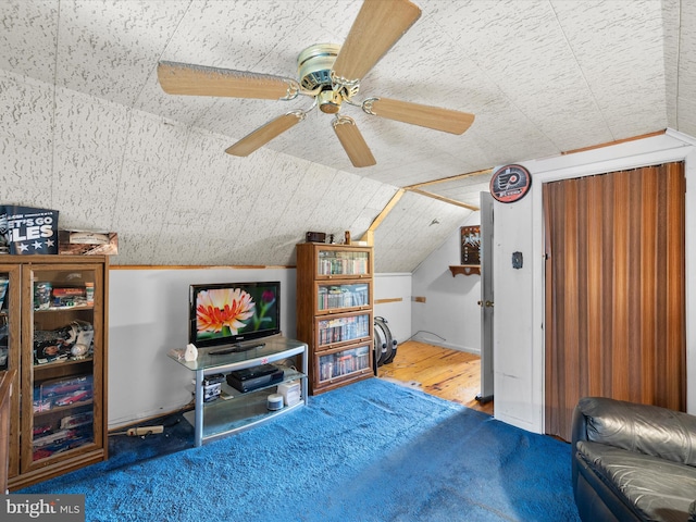 bedroom with ceiling fan, hardwood / wood-style floors, and vaulted ceiling