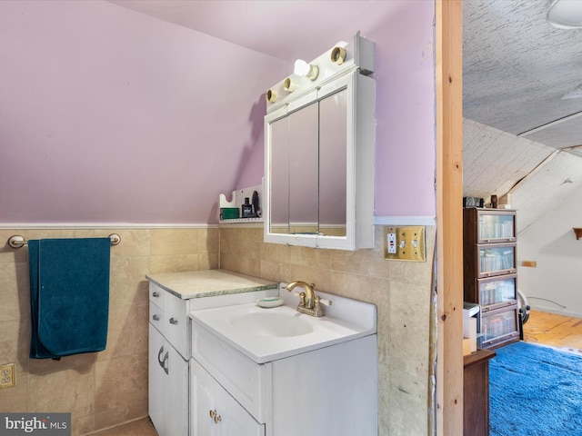 bathroom featuring vanity, tile walls, and hardwood / wood-style floors