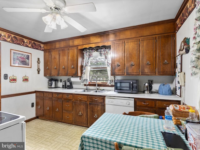 kitchen with ceiling fan, white dishwasher, sink, and range