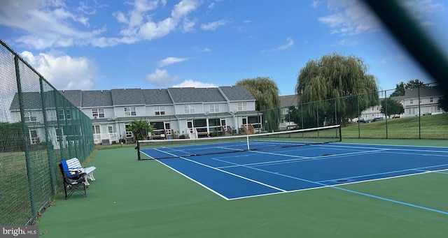 view of tennis court with basketball hoop