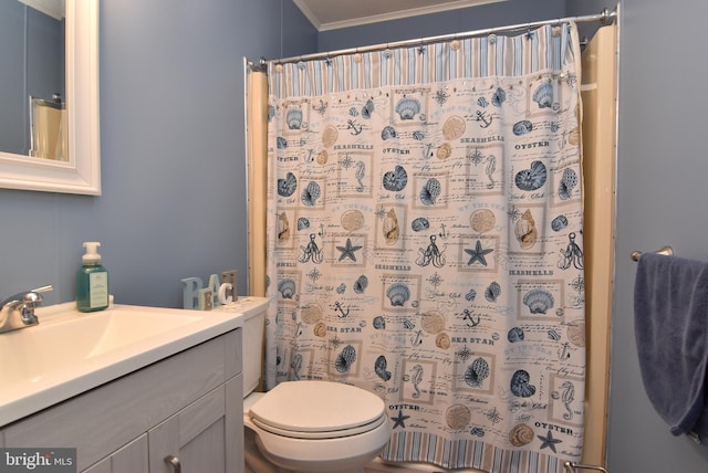 bathroom with walk in shower, crown molding, vanity, and toilet