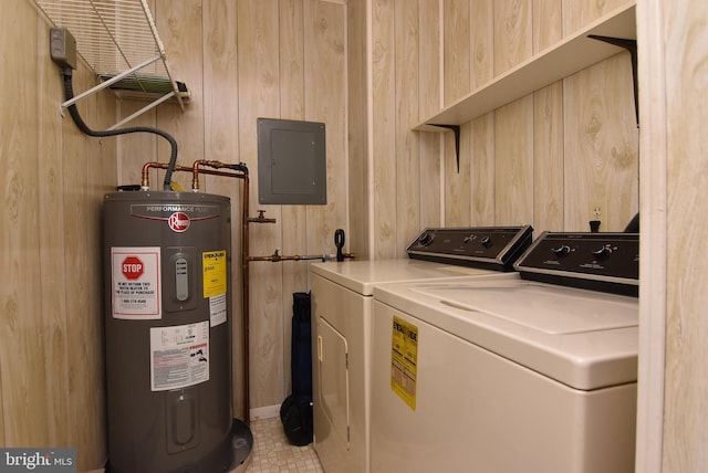 washroom with electric panel, wooden walls, washing machine and clothes dryer, and electric water heater