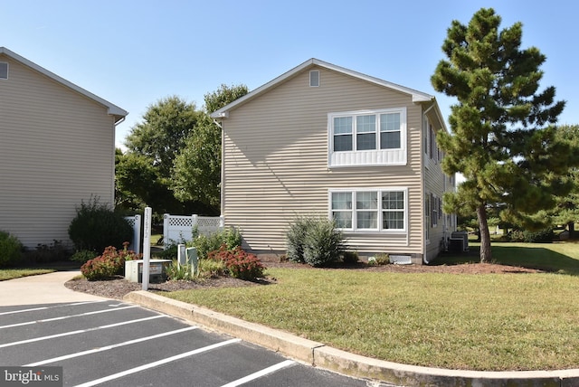 view of property exterior featuring a lawn