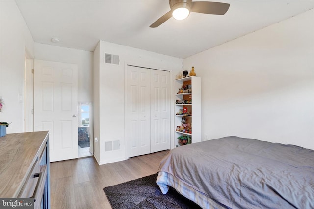 bedroom featuring ceiling fan, a closet, and dark hardwood / wood-style floors