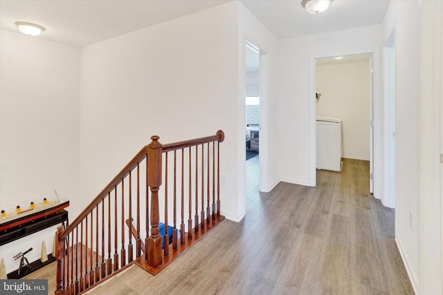 hallway featuring light wood-type flooring and washer / clothes dryer