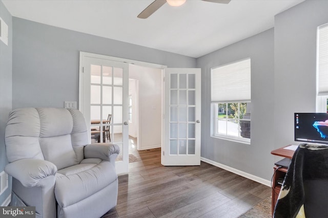 sitting room with french doors, hardwood / wood-style floors, and ceiling fan